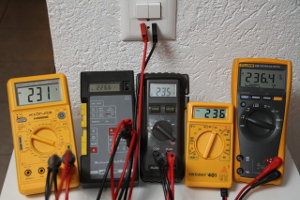 Five multimeters reading the mains voltage: they don't all agree on the same value. It's a good idea to verify your instruments first. (click to enlarge)