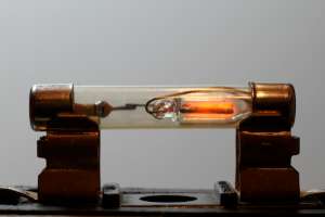This glow lamp is in a fuse-like glass package and its ballast resistor is clearly visible. (click to enlarge)