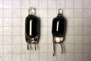 Picture of two glow lamps after several years of service. The glass is now completely black and the glow cannot be seen anymore, but electrically they still work. (click to enlarge)