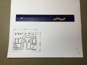 Test print on a blank A4 sheet. The hand-drawn arrow on the right helps placing the paper in the correct way in the printer tray; the ruler is to check that the scale is exactly 1:1; the text on the PCB should appear as mirrored. (click to enlarge)